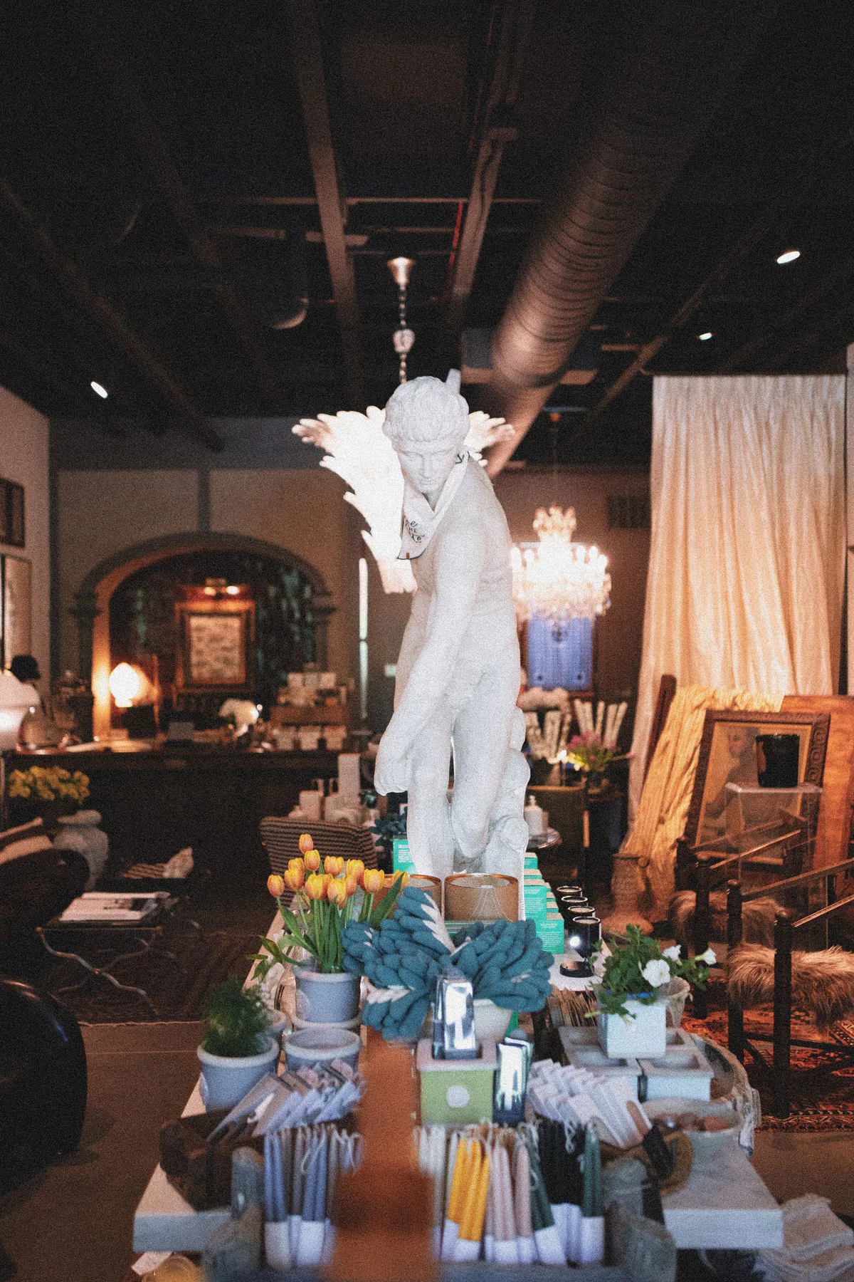 Layered boutique interior with art and sculptural objects