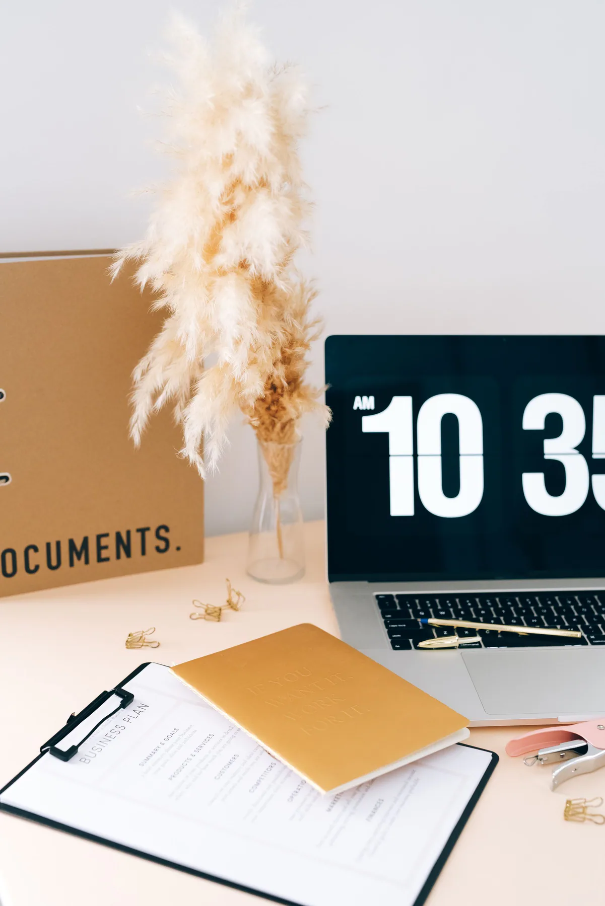 Organized neutral workspace with documents and a laptop