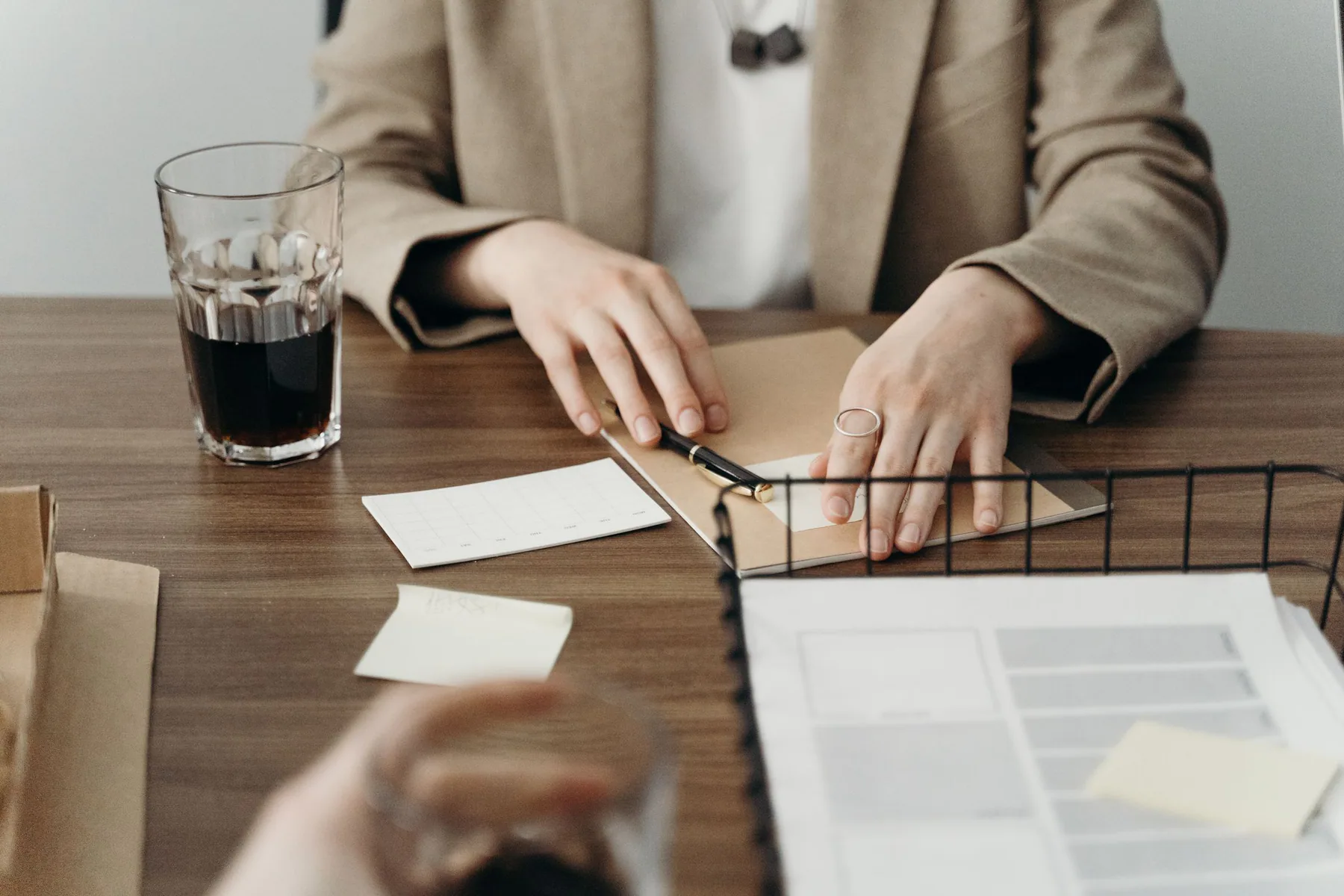 Hands reviewing organized paperwork at a quiet desk