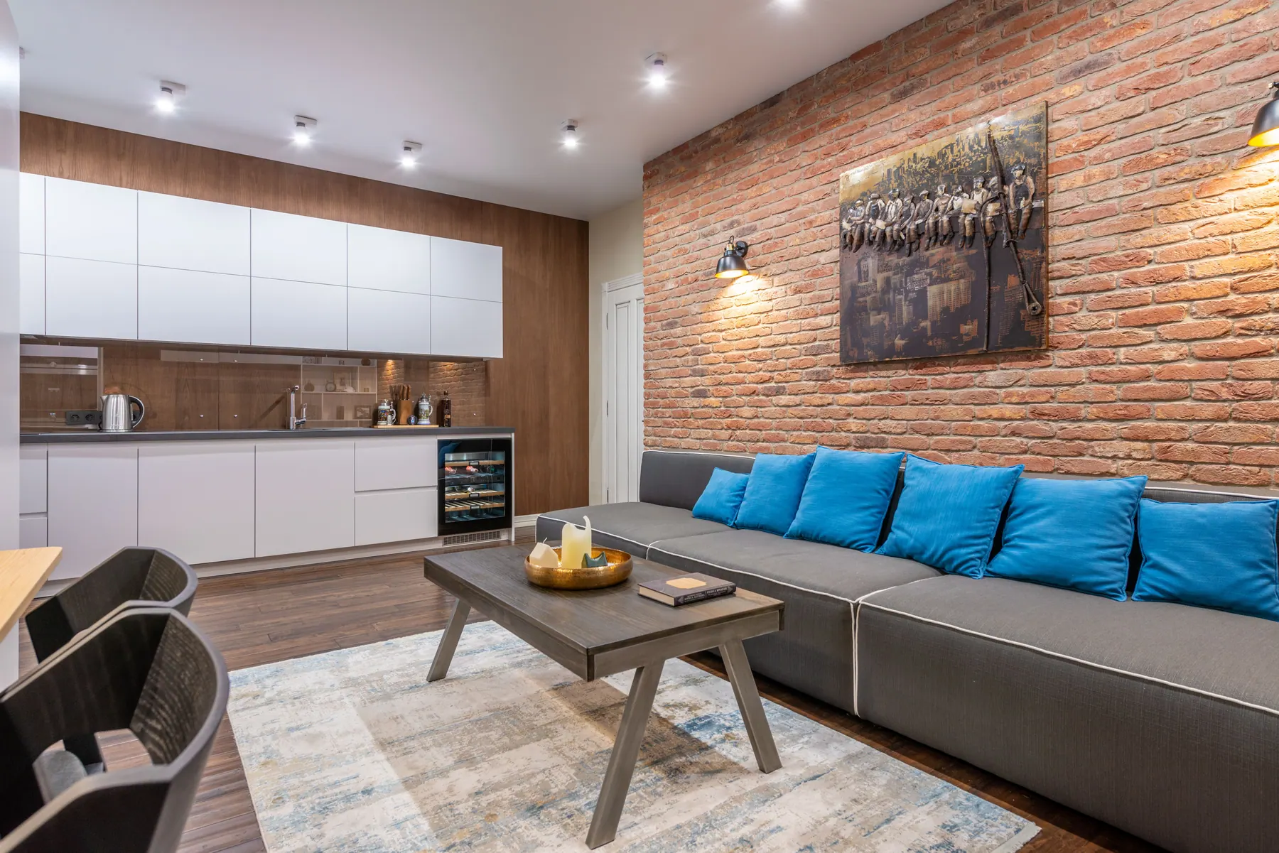 Warm modern interior with artwork displayed on a brick feature wall