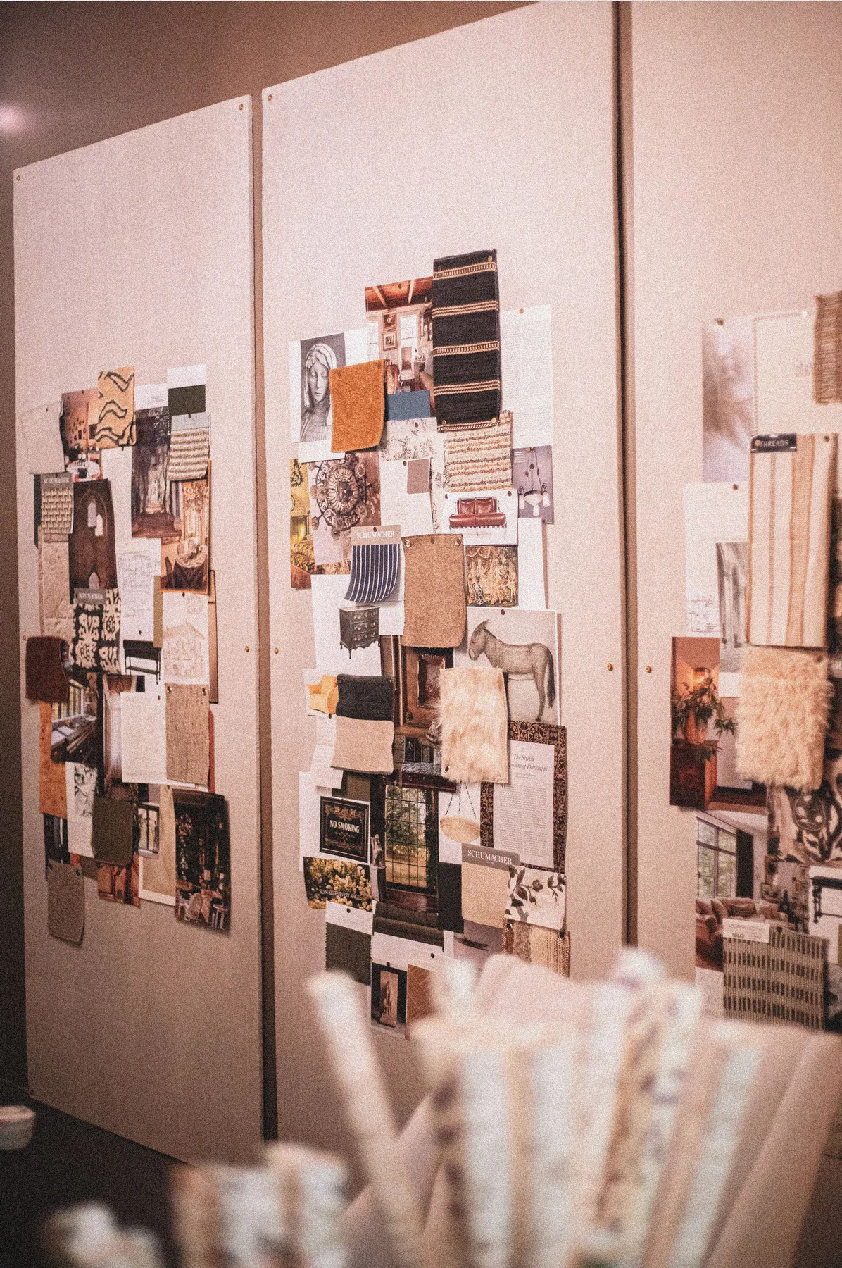 Interior material and image studies pinned to studio boards